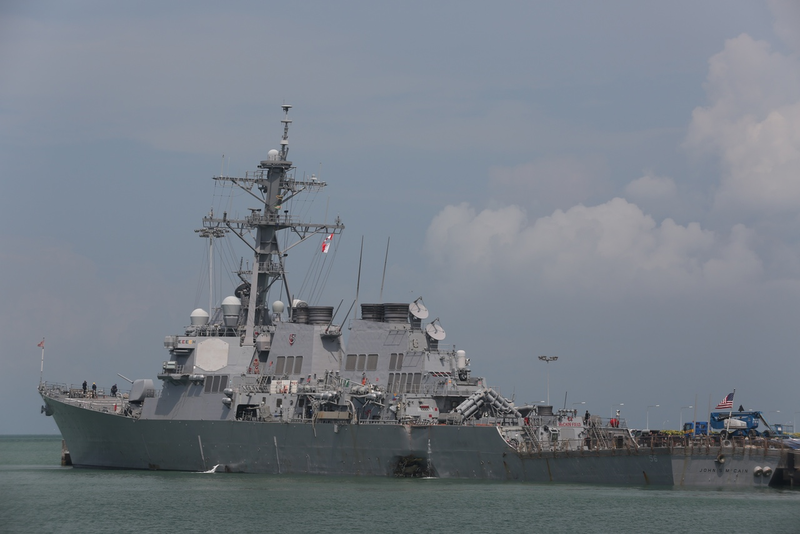 Damage to the USS John S. McCain is visible as it steers towards Changi Naval Base in Singapore following a collision (U.S. Navy photo by Mass Communication Specialist 2nd Class Joshua Fulton/Released)